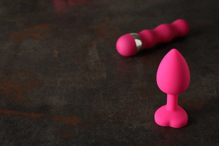 Sex toys of pink color on a dark backgroundの写真素材