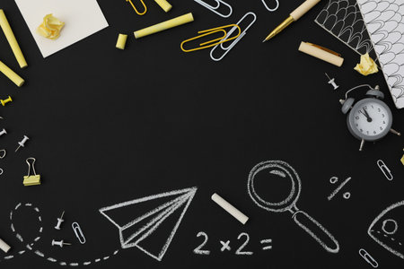 School supplies on a school board with a formula written in chalk, place for text