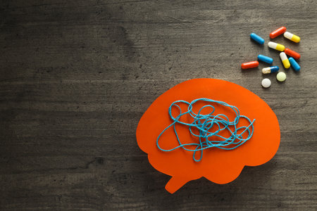Paper brains with tangled thread with space for text