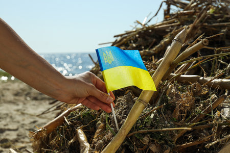 The flag of Ukraine against the background of water pollution with plastic waste and garbageの写真素材
