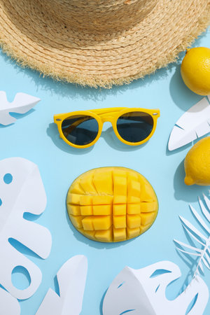 Top view, still life summer concept with coconut, mango, glasses and hatの写真素材