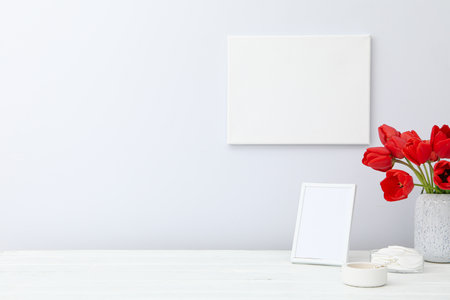 Table frame and canvas on wall with blank areaの写真素材