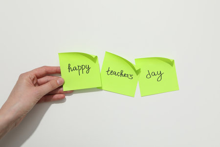 Green notes and female hand on white backgroundの写真素材