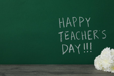Happy teacher's day greetings, inscription on a green boardの写真素材