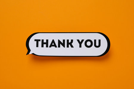 The inscription thank you in the form of a message on an orange backgroundの写真素材