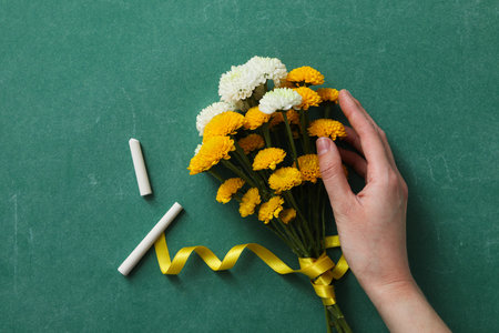 Flowers on a green school blackboard with chalkの写真素材