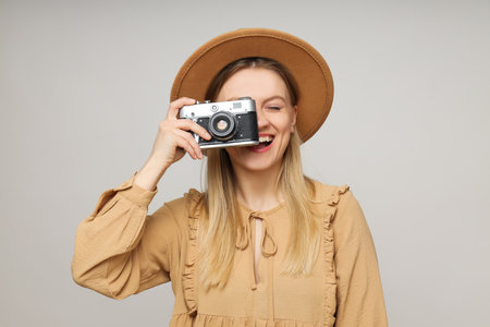 Concept of leisure with young woman with retro photo cameraの写真素材