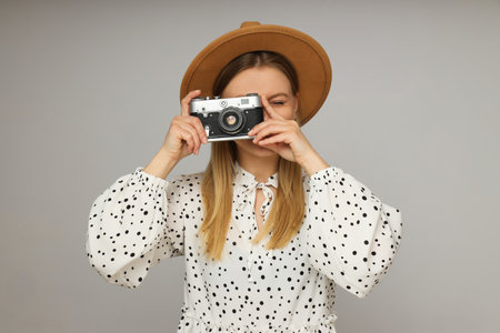 Concept of leisure with young woman with retro photo cameraの写真素材