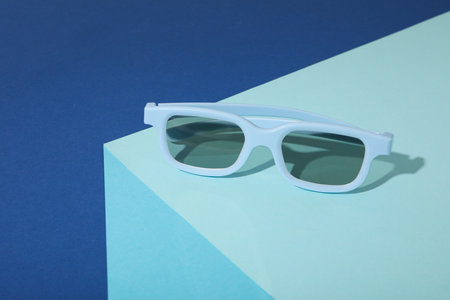 Blue sunglasses on blue table and dark blue backgroundの写真素材