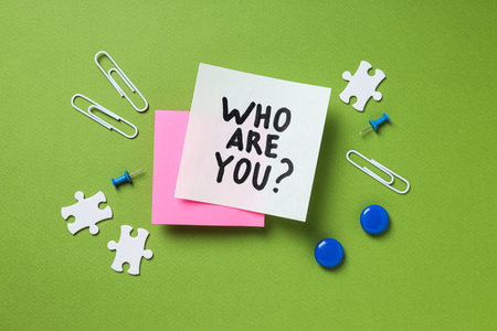 Paper notes with text, puzzles and paper clips on green background