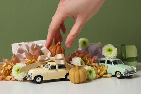 Toy retro cars with gifts, flowers and a pumpkinの写真素材