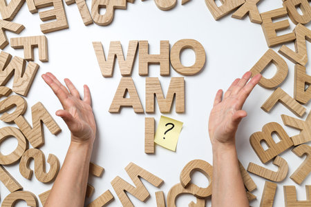 Text from wooden letters and female hands on white background