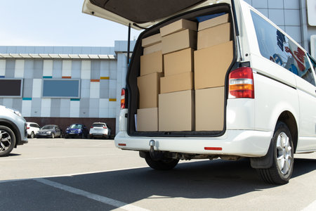A white delivery service car with boxes insideの写真素材