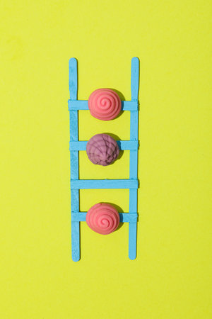 Stepladder and jelly candies on green background, top viewの写真素材