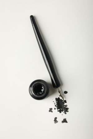 Ink blot, pen and ink bottle on white background, top viewの写真素材