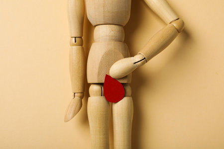 Menstrual cycle concept, wooden figurine of a man with a red dropの写真素材