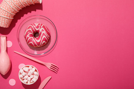 Donut, balloon, paper cups and marshmallows on pink background, space for textの写真素材