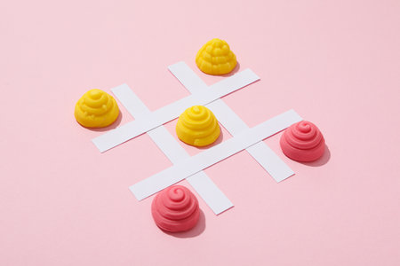Playing with jelly candies on pink background