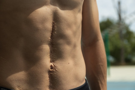Male figure, abs close-up, sunlightの写真素材