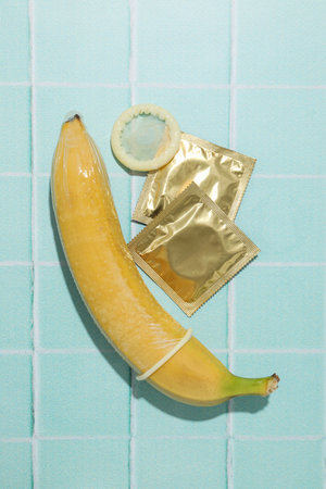 Condoms on bananas on a blue backgroundの写真素材