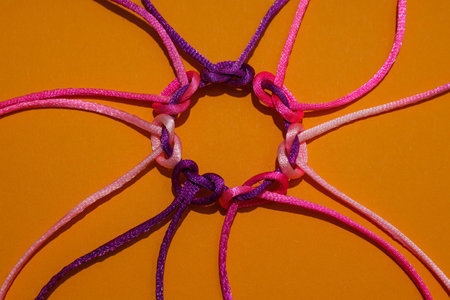 Braided multi-colored cords, painted tied together. The concept of creative cooperation and...