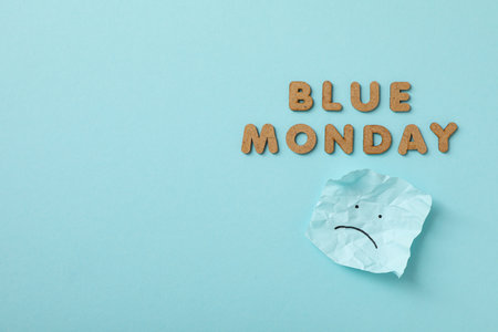 Blue Monday text and paper with sad emoji on blue background, space for textの写真素材