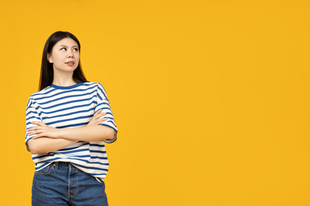 Beautiful Asian girl with folded hands looking upの写真素材