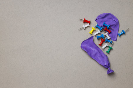 Bursting balloon and needles on gray background, space for textの写真素材
