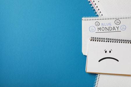 Notepads with text Blue Monday on blue background, space for textの写真素材