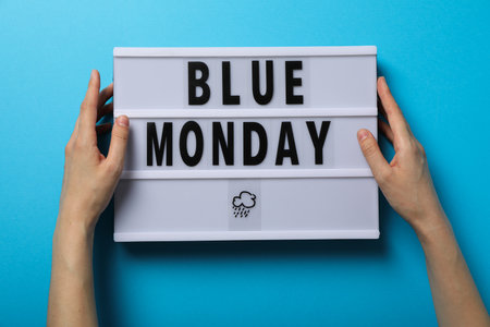 Blue Monday text and female hands on blue background, top viewの写真素材