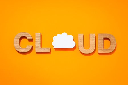 The word "Cloud" in wooden letters on a yellow backgroundの写真素材