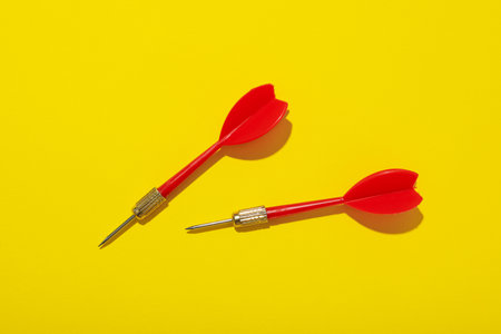 Darts for hitting the target on a yellow background.の写真素材