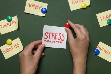 Papers with words and hands on dark green background, top viewの写真素材