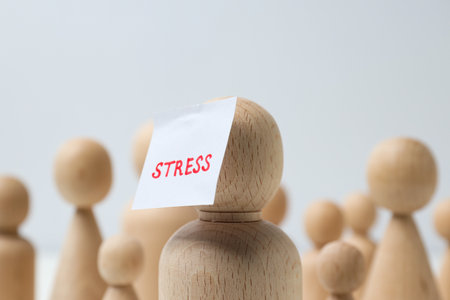 Wooden figurines and paper with the word Stress on white background, close upの写真素材
