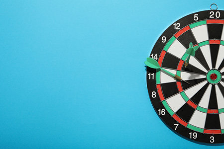 Darts hitting the target with wires on a blue background. close up.の写真素材