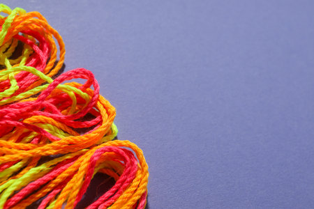 Close-up of green, orange and red braided shoelaces. Space for textの写真素材