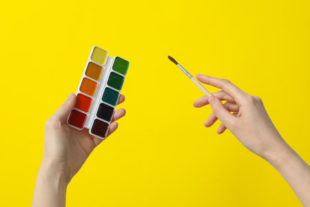 Palette of multi-colored paints in female handsの写真素材