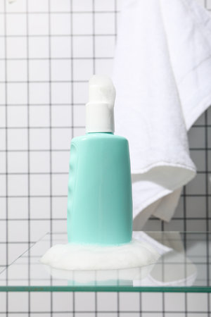 A bottle with a care product in foam.の写真素材