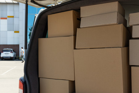 A white delivery service car with boxes insideの写真素材