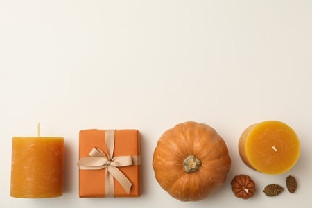 Candles, pumpkins and box on white background, space for textの写真素材