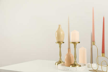 Candles in holders on white background, space for textの写真素材