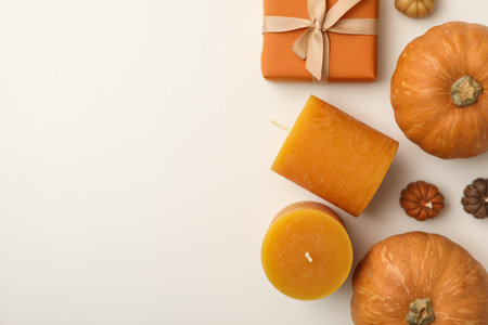 Candles, pumpkins and box on white background, space for textの写真素材