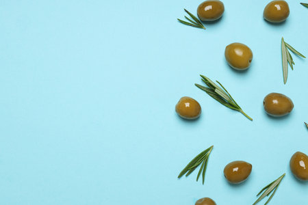 Olives and leaves on blue background, space for textの写真素材