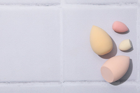 Cosmetic sponges on gray background, space for textの写真素材