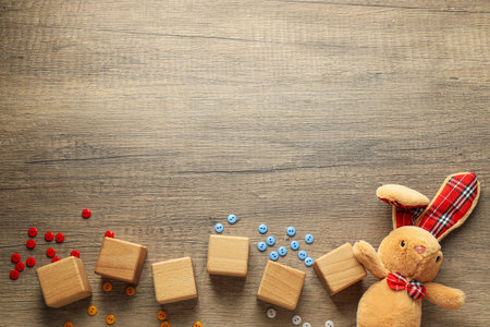 Wooden cubes with multi-colored buttons on a wooden background, place for text. world autism day conceptの写真素材