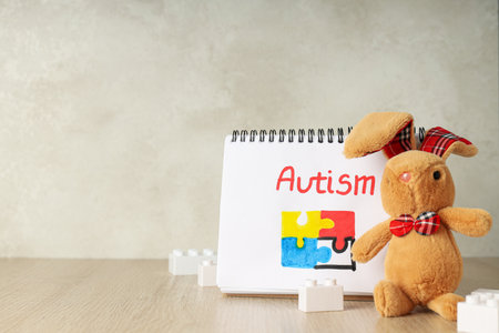 Notebook with the inscription "autism" on a light background, place for text. world autism day conceptの写真素材