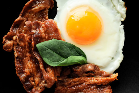Tasty breakfast and delicious meat food concept - fried bacon