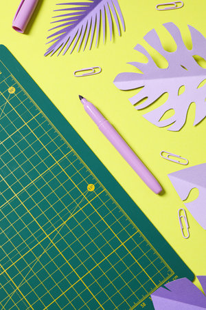 Patchwork accessories concept on yellow background, mat cutting
