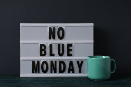 Text No Blue Monday and cup on dark blue backgroundの写真素材
