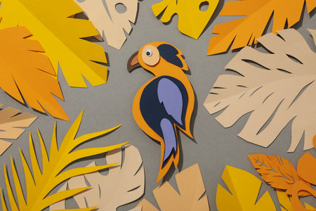 Paper peach tropical leaves on a gray background. With birds.の写真素材